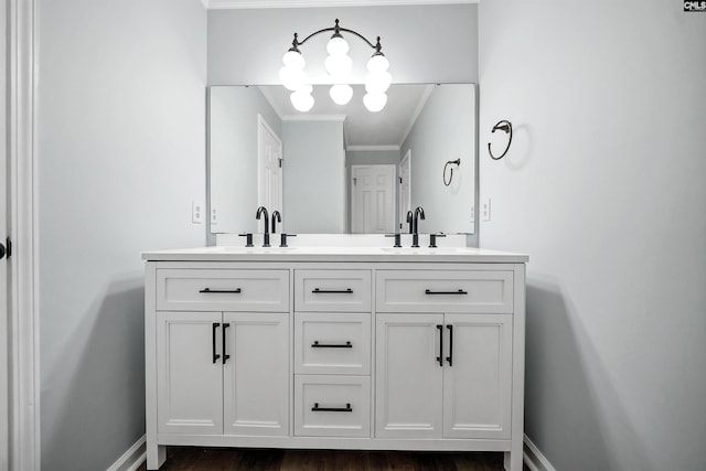 bathroom with a sink, baseboards, and double vanity