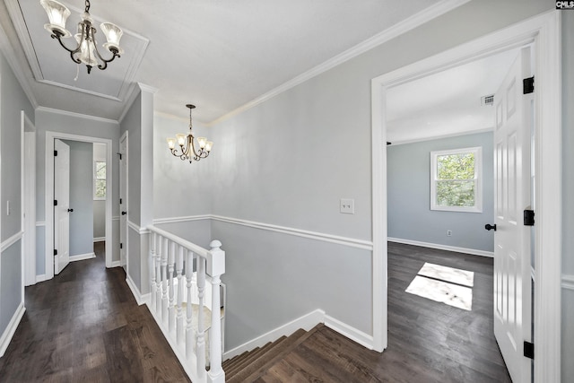 hall with a notable chandelier, ornamental molding, an upstairs landing, wood finished floors, and baseboards