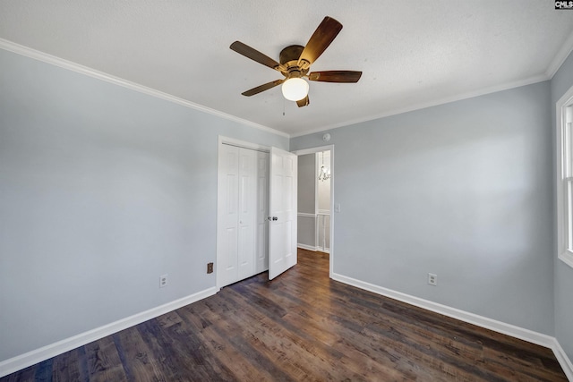 unfurnished bedroom with dark wood-style floors, baseboards, a closet, and ornamental molding