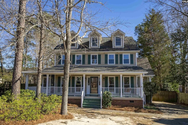 view of front facade featuring covered porch and fence