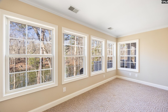 unfurnished sunroom featuring a wealth of natural light and visible vents