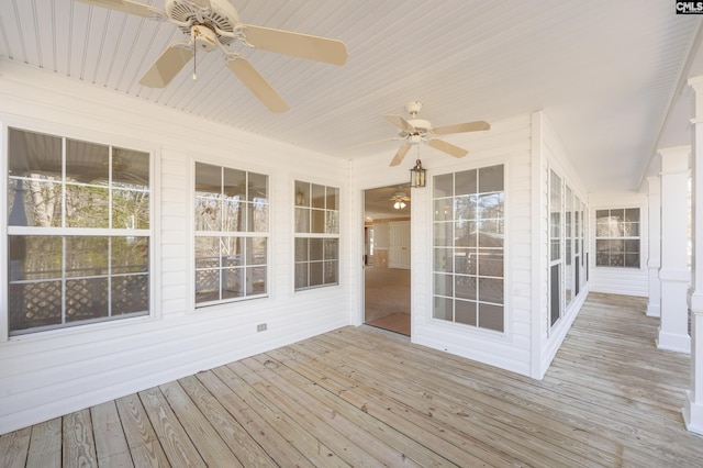 wooden deck featuring a ceiling fan