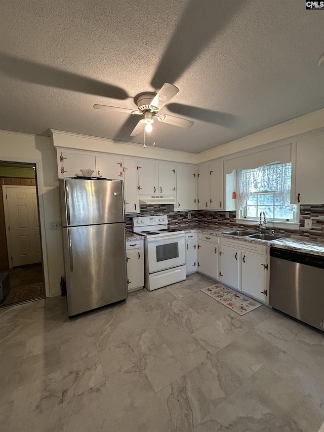 kitchen with marble finish floor, appliances with stainless steel finishes, a sink, and white cabinets