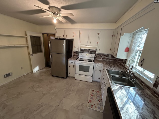 kitchen featuring under cabinet range hood, a sink, white cabinetry, electric stove, and freestanding refrigerator