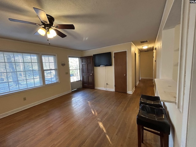 entryway featuring visible vents, baseboards, dark wood finished floors, ceiling fan, and a textured ceiling