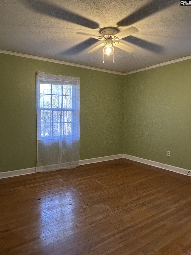 unfurnished room featuring a textured ceiling, dark wood-type flooring, baseboards, and crown molding