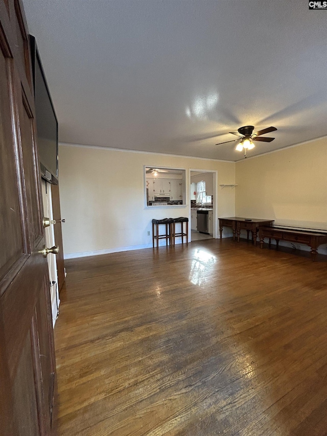 unfurnished living room featuring a ceiling fan and wood finished floors