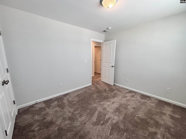 unfurnished bedroom featuring carpet flooring, visible vents, and baseboards