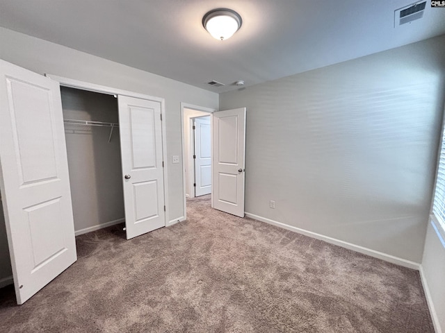 unfurnished bedroom featuring carpet flooring, visible vents, and baseboards