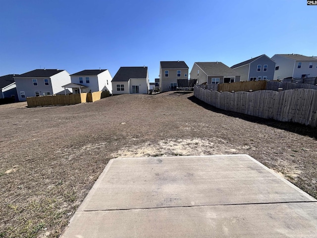 view of yard with a residential view and fence