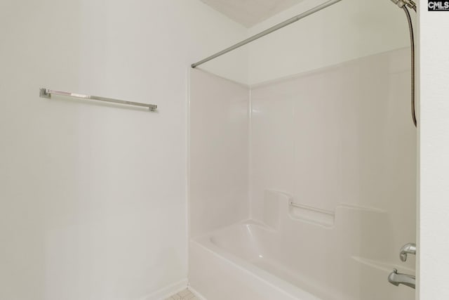 full bath with tile patterned floors, baseboards, and bathing tub / shower combination