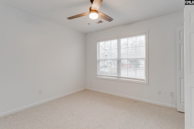 unfurnished room featuring carpet flooring, visible vents, and baseboards