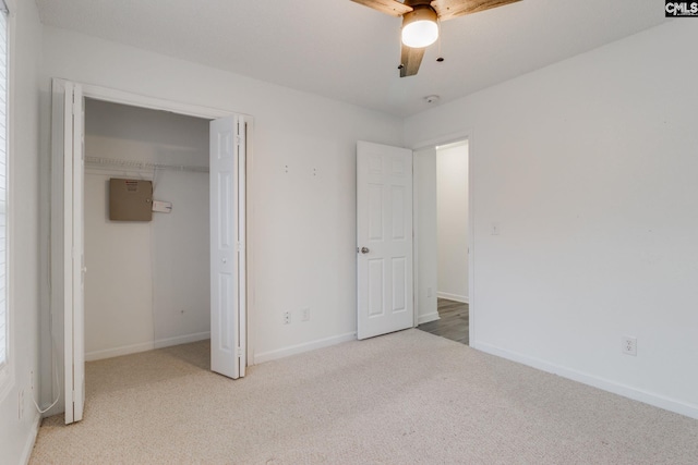 unfurnished bedroom with a ceiling fan, a closet, baseboards, and carpet flooring