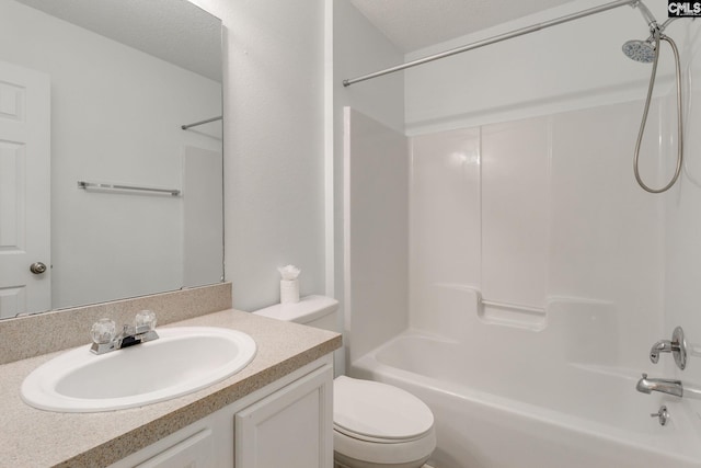 bathroom with tub / shower combination, vanity, toilet, and a textured ceiling