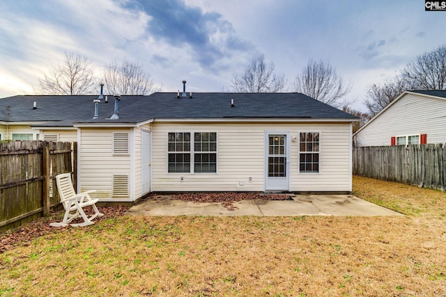 back of house with a yard, a patio, and a fenced backyard