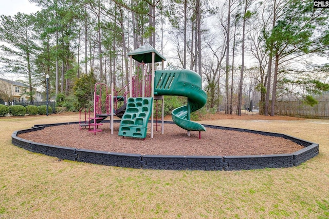 community playground with a lawn and fence