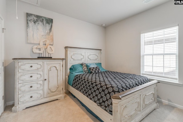 bedroom with attic access, light colored carpet, visible vents, and baseboards