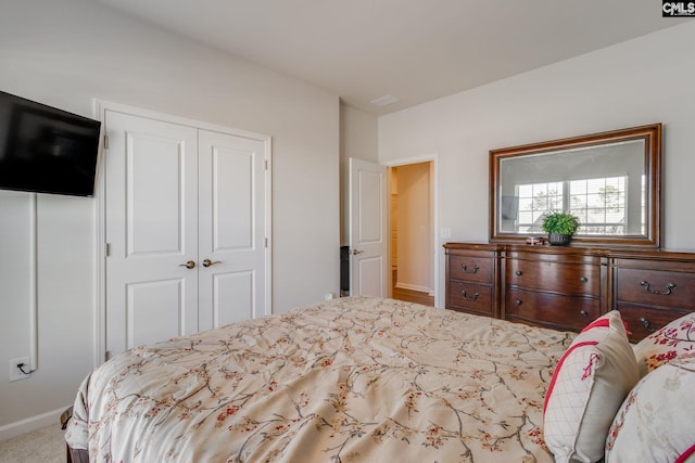 carpeted bedroom featuring a closet