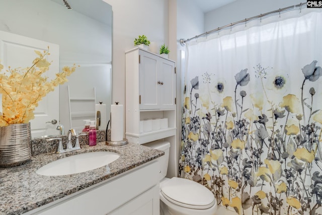 full bath with a shower with curtain, vanity, and toilet