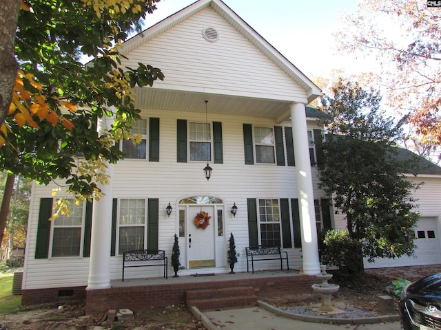 view of front of house featuring a porch and a garage