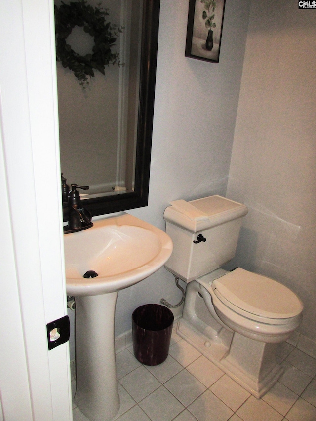 bathroom with toilet and tile patterned floors