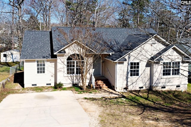 view of front of home featuring crawl space, a shingled roof, and fence