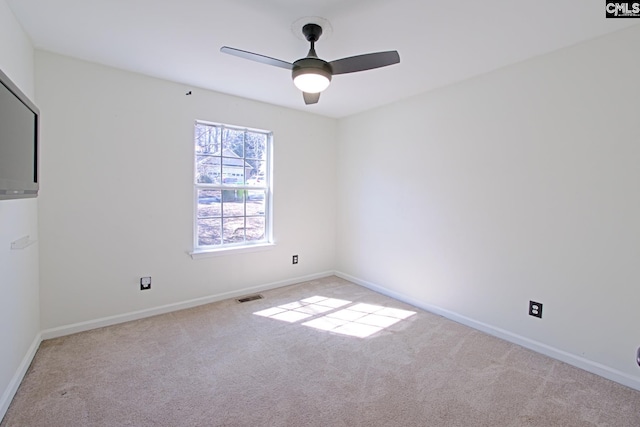 spare room featuring a ceiling fan, carpet flooring, visible vents, and baseboards