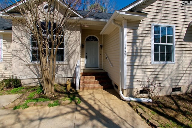 doorway to property with roof with shingles and crawl space