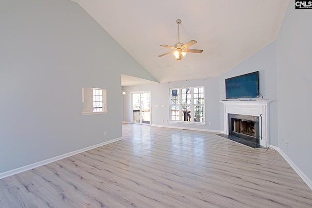 unfurnished living room featuring ceiling fan, baseboards, a high end fireplace, and light wood-style floors