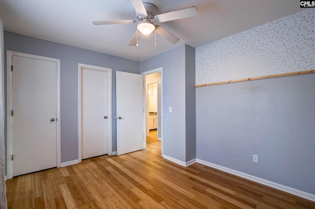 unfurnished bedroom featuring ceiling fan, light wood finished floors, and baseboards