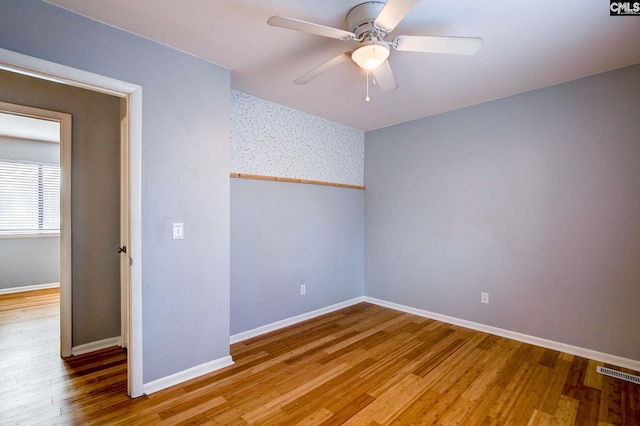 unfurnished bedroom featuring visible vents, ceiling fan, baseboards, and wood finished floors