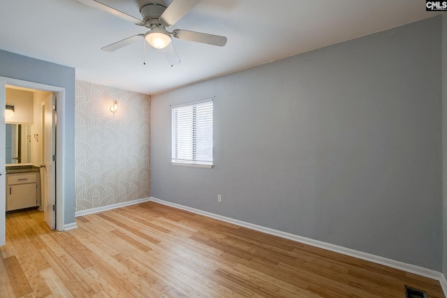 unfurnished bedroom with baseboards, visible vents, and light wood-style floors