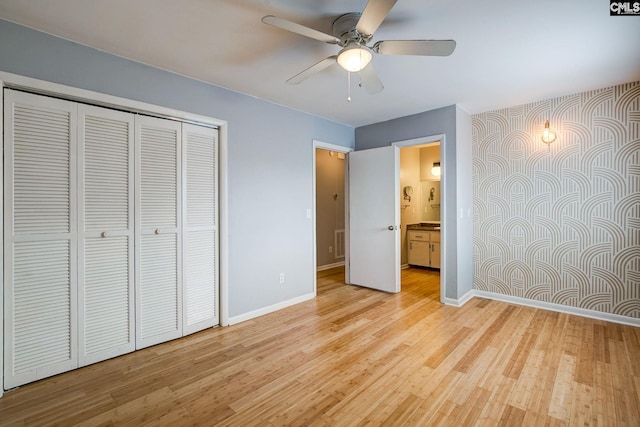 unfurnished bedroom with light wood finished floors, visible vents, baseboards, a ceiling fan, and a closet