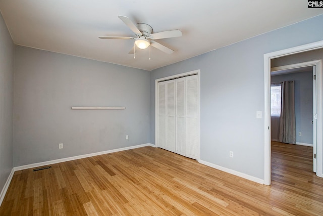 unfurnished bedroom with visible vents, baseboards, light wood-style flooring, ceiling fan, and a closet