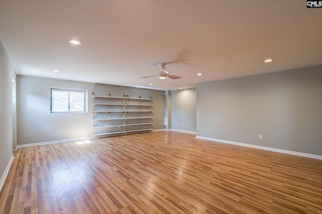 spare room with light wood-type flooring, baseboards, a ceiling fan, and recessed lighting