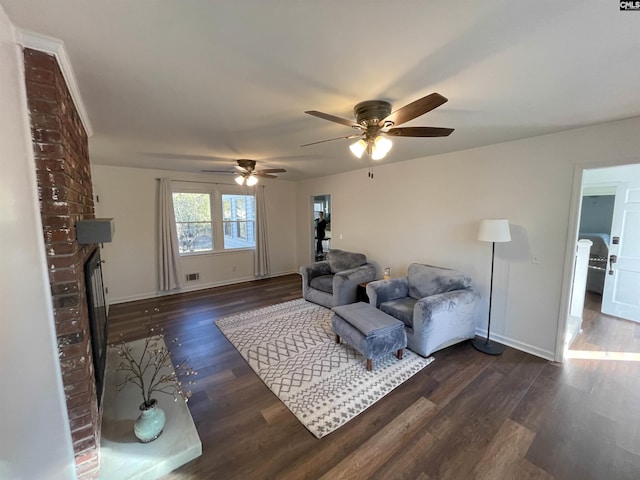 living room with visible vents, a fireplace, baseboards, and dark wood finished floors