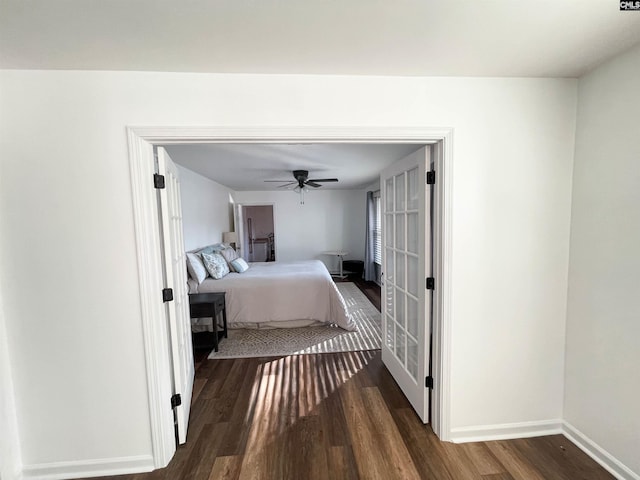 bedroom featuring ceiling fan, wood finished floors, and baseboards