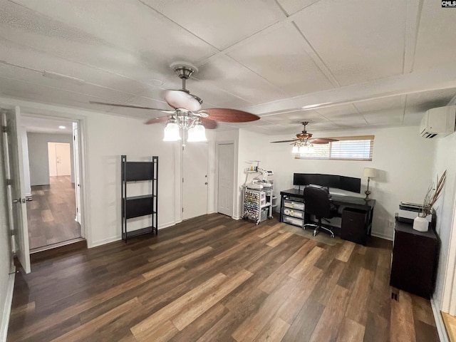 home office featuring dark wood-style floors, an AC wall unit, and baseboards