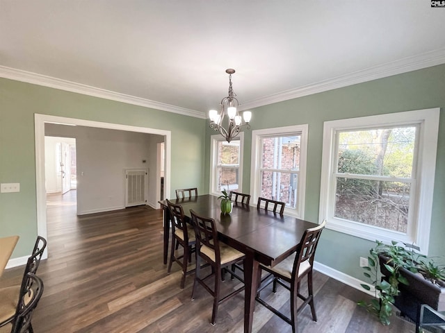 dining area featuring crown molding, dark wood finished floors, and baseboards