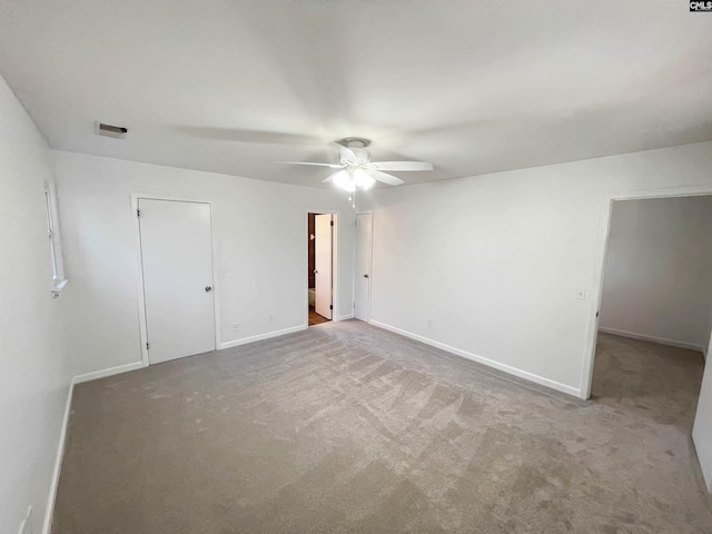 unfurnished bedroom with ceiling fan, visible vents, baseboards, and carpet flooring