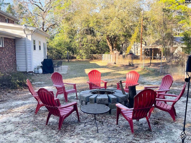 view of patio with fence and a fire pit