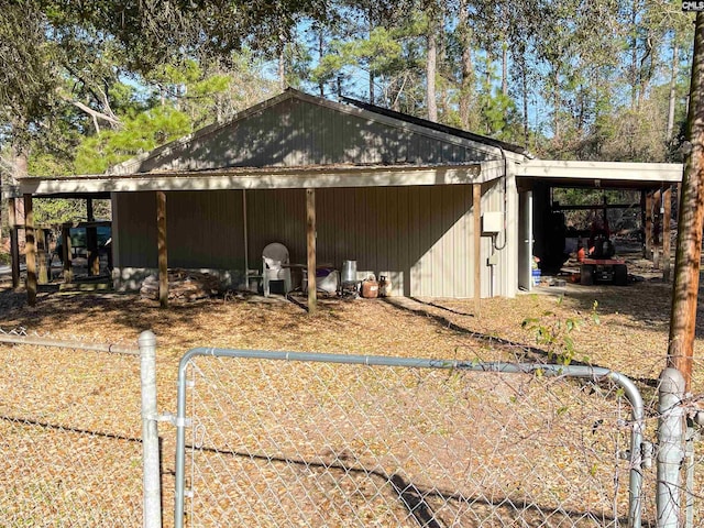 view of pole building with a carport and fence