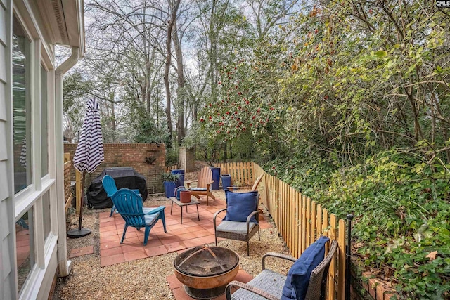 view of patio / terrace with a fenced backyard and an outdoor fire pit