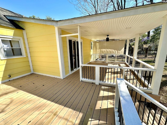 wooden deck with a ceiling fan