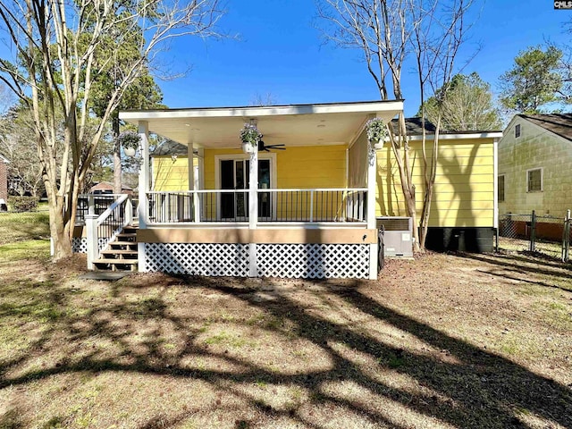 back of property featuring fence, central AC unit, and a ceiling fan