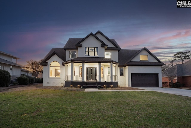 modern inspired farmhouse featuring driveway, a lawn, crawl space, a porch, and stucco siding