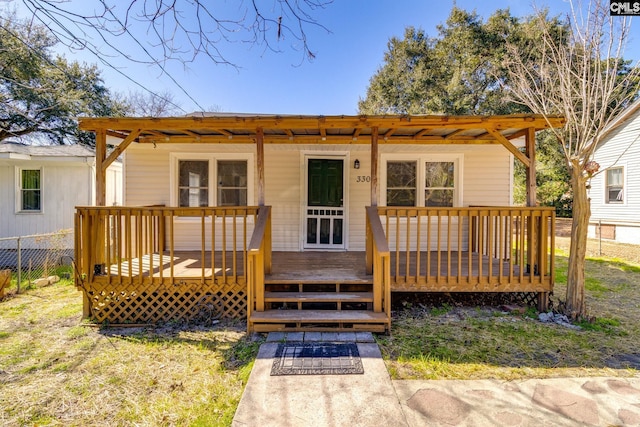 back of house with fence