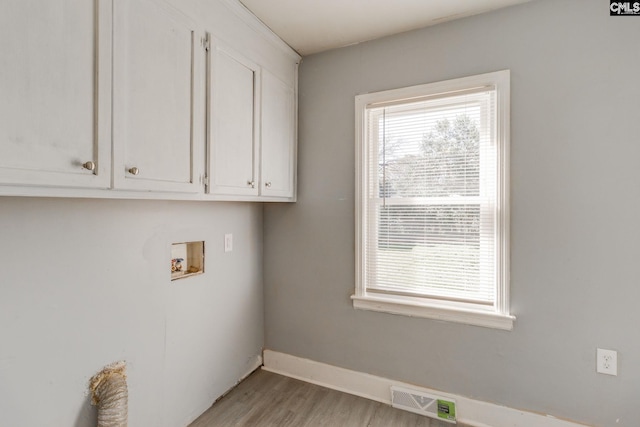 laundry area with hookup for a washing machine, a healthy amount of sunlight, visible vents, and light wood-style flooring