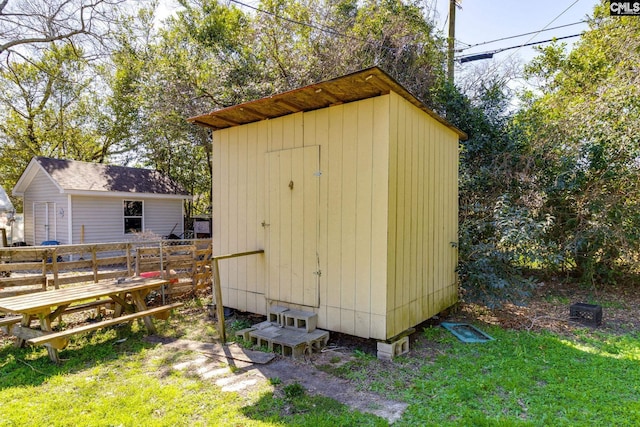 view of shed with fence