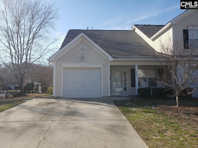 view of front of property featuring a garage, concrete driveway, covered porch, and a shingled roof